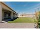Inviting backyard with a covered patio, artificial grass, and mature landscaping at 1229 N 106Th Pl, Mesa, AZ 85207