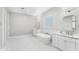 Bright bathroom featuring a stand alone tub and double sinks with marble countertops at 1229 N 106Th Pl, Mesa, AZ 85207