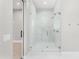 Modern glass enclosed shower with double shower heads, marble tile surround, and sleek fixtures at 1229 N 106Th Pl, Mesa, AZ 85207
