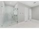 Luxurious bathroom with glass enclosed shower featuring white tile and brass fixtures at 1229 N 106Th Pl, Mesa, AZ 85207