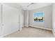Minimalist bedroom with closet doors and a window offering natural light and neighborhood views at 1229 N 106Th Pl, Mesa, AZ 85207