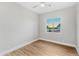 Well lit bedroom featuring hardwood flooring and natural light from the window at 1229 N 106Th Pl, Mesa, AZ 85207