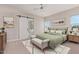 Serene bedroom with stylish accents including a tufted headboard, sliding barn door, and decorative rug for added comfort at 1229 N 106Th Pl, Mesa, AZ 85207
