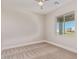Comfortable bedroom with neutral tones, plush carpeting and a ceiling fan at 1229 N 106Th Pl, Mesa, AZ 85207