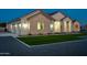 Charming exterior showcasing manicured landscaping, stone accents, and ample parking with a three car garage at 1229 N 106Th Pl, Mesa, AZ 85207