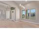 Well-lit living room with an open layout, light wood floors, and large windows at 1229 N 106Th Pl, Mesa, AZ 85207