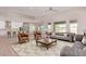 Cozy living room showcasing an open concept layout with a kitchen and dining area, and stylish furniture at 1229 N 106Th Pl, Mesa, AZ 85207