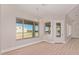 Open concept living area with a large window and a glass door with access to the backyard at 1229 N 106Th Pl, Mesa, AZ 85207