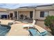 Covered back patio with outdoor seating, grill, and a view of the refreshing pool at 1264 W 6Th Ave, Apache Junction, AZ 85120