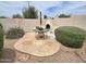 Cozy backyard patio with flagstone, outdoor fireplace, mature landscaping, and sunny Arizona skies at 1264 W 6Th Ave, Apache Junction, AZ 85120