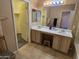 Bathroom with double vanity, large mirror, and a doorway to a walk-in closet at 1264 W 6Th Ave, Apache Junction, AZ 85120