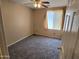 Cozy carpeted bedroom with neutral walls, a window, and a ceiling fan at 1264 W 6Th Ave, Apache Junction, AZ 85120