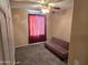 Bedroom featuring a ceiling fan, carpeting, and a brown futon at 1264 W 6Th Ave, Apache Junction, AZ 85120