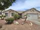 Charming single story home showcasing a low maintenance desert landscape and two-car garage at 1264 W 6Th Ave, Apache Junction, AZ 85120