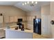 This open kitchen offers generous counter space and a large black refrigerator at 1264 W 6Th Ave, Apache Junction, AZ 85120