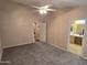 This main bedroom offers carpeting and a door to the ensuite bathroom at 1264 W 6Th Ave, Apache Junction, AZ 85120