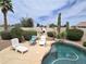 Inviting backyard pool area with lounge chairs, desert landscaping, and sunny Arizona skies at 1264 W 6Th Ave, Apache Junction, AZ 85120