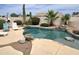 A relaxing pool featuring a waterfall, surrounded by rock and palm trees at 1264 W 6Th Ave, Apache Junction, AZ 85120