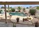 Inviting pool area with a waterfall feature, lush landscaping, and shaded seating at 1264 W 6Th Ave, Apache Junction, AZ 85120