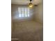 A carpeted bedroom with a ceiling fan and shuttered windows, providing a serene retreat at 1320 E Bellerive Dr, Chandler, AZ 85249