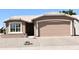 Charming single-story home with desert landscaping, a two-car garage, and a neutral color palette at 1320 E Bellerive Dr, Chandler, AZ 85249