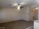 A spacious living room with neutral paint, a ceiling fan, and tiled floors at 1320 E Bellerive Dr, Chandler, AZ 85249