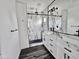 Modern bathroom featuring a double sink vanity, large mirrors, and a glass enclosed shower at 1401 S Rita Ln, Tempe, AZ 85281