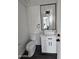 Elegant half bath with modern vessel sink, marble countertop, and sleek black fixtures at 1401 S Rita Ln, Tempe, AZ 85281