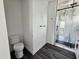 Bathroom with a toilet and a glass enclosed shower featuring stylish design at 1401 S Rita Ln, Tempe, AZ 85281