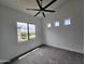 Bedroom with a large window and three high smaller windows at 1401 S Rita Ln, Tempe, AZ 85281