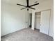 Bedroom with a large window, ceiling fan, and a sliding door closet at 1401 S Rita Ln, Tempe, AZ 85281