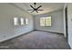 Bright bedroom featuring a ceiling fan, neutral carpet, three windows and a large window at 1401 S Rita Ln, Tempe, AZ 85281