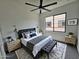 Bedroom with a large window, ceiling fan, and gray color scheme at 1401 S Rita Ln, Tempe, AZ 85281