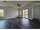 Bright bedroom with hardwood floors, ceiling fan, and sliding door to a balcony at 1401 S Rita Ln, Tempe, AZ 85281