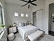Bedroom with a large window, ceiling fan, and a sliding door closet at 1401 S Rita Ln, Tempe, AZ 85281