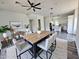 Dining room with hardwood floors, modern light fixtures and a large wood table at 1401 S Rita Ln, Tempe, AZ 85281
