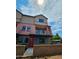 Townhouse exterior featuring a red door, brick accents, balconies, and modern architectural design at 1401 S Rita Ln, Tempe, AZ 85281