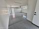 Spacious three-car garage with epoxy flooring and modern doors at 1401 S Rita Ln, Tempe, AZ 85281