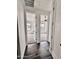 Hallway featuring wood floors and doorways into two rooms with neutral carpet and windows at 1401 S Rita Ln, Tempe, AZ 85281