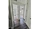 Hallway with wood floors and open doorways into rooms with neutral carpet at 1401 S Rita Ln, Tempe, AZ 85281
