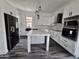 Bright kitchen with white cabinets, marble countertops, an island, and stainless steel appliances at 1401 S Rita Ln, Tempe, AZ 85281