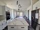 Open kitchen featuring a marble-top island, stainless steel appliances, and modern lighting fixtures at 1401 S Rita Ln, Tempe, AZ 85281