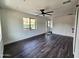Modern living area featuring hardwood floors, a ceiling fan, and bright natural light at 1401 S Rita Ln, Tempe, AZ 85281