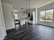 Open-concept living room with dark hardwood floors, kitchen island, and natural light at 1401 S Rita Ln, Tempe, AZ 85281