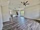 Open living room with dark wood floors and a view of the modern kitchen at 1401 S Rita Ln, Tempe, AZ 85281