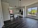 Open-concept living room with dark hardwood floors, kitchen island, and natural light at 1401 S Rita Ln, Tempe, AZ 85281