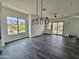 Bright, open living room with dark hardwood floors and large windows at 1401 S Rita Ln, Tempe, AZ 85281
