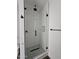 Shower features a glass door, black hardware, and pebble shower floor at 1401 S Rita Ln, Tempe, AZ 85281