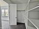 Organized walk-in closet featuring neutral carpet and built-in shelving for storage at 1401 S Rita Ln, Tempe, AZ 85281