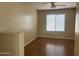 A bright bedroom with a ceiling fan and natural light, with neutral paint and laminate flooring at 14228 N 150Th Ln, Surprise, AZ 85379